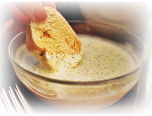 dipping bread into caesar dressing
