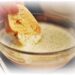 dipping bread into caesar dressing