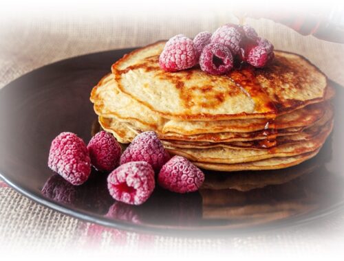 pancakes topped with fruit and syrup