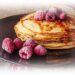 pancakes topped with fruit and syrup