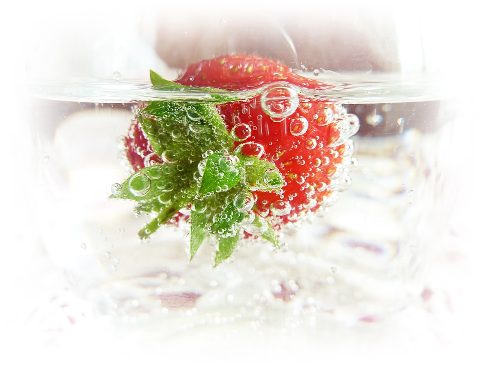 chilling a drink with a frozen strawberry