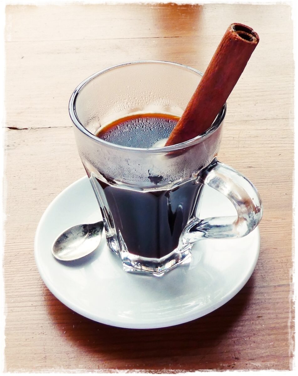 cinammon stick stirrer in a glass of coffee